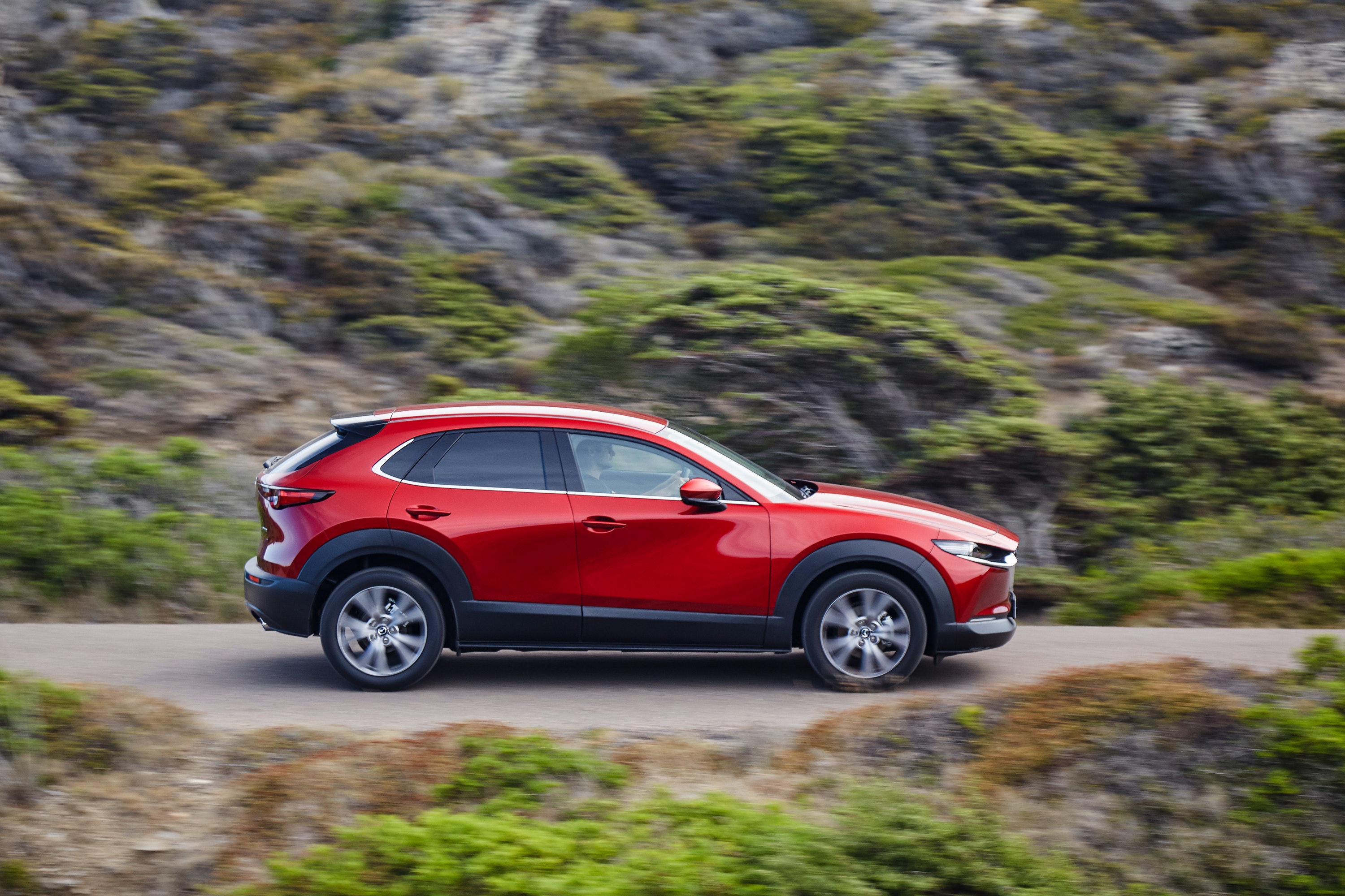 Side view of Mazda CX-30 driving on a road.jpg